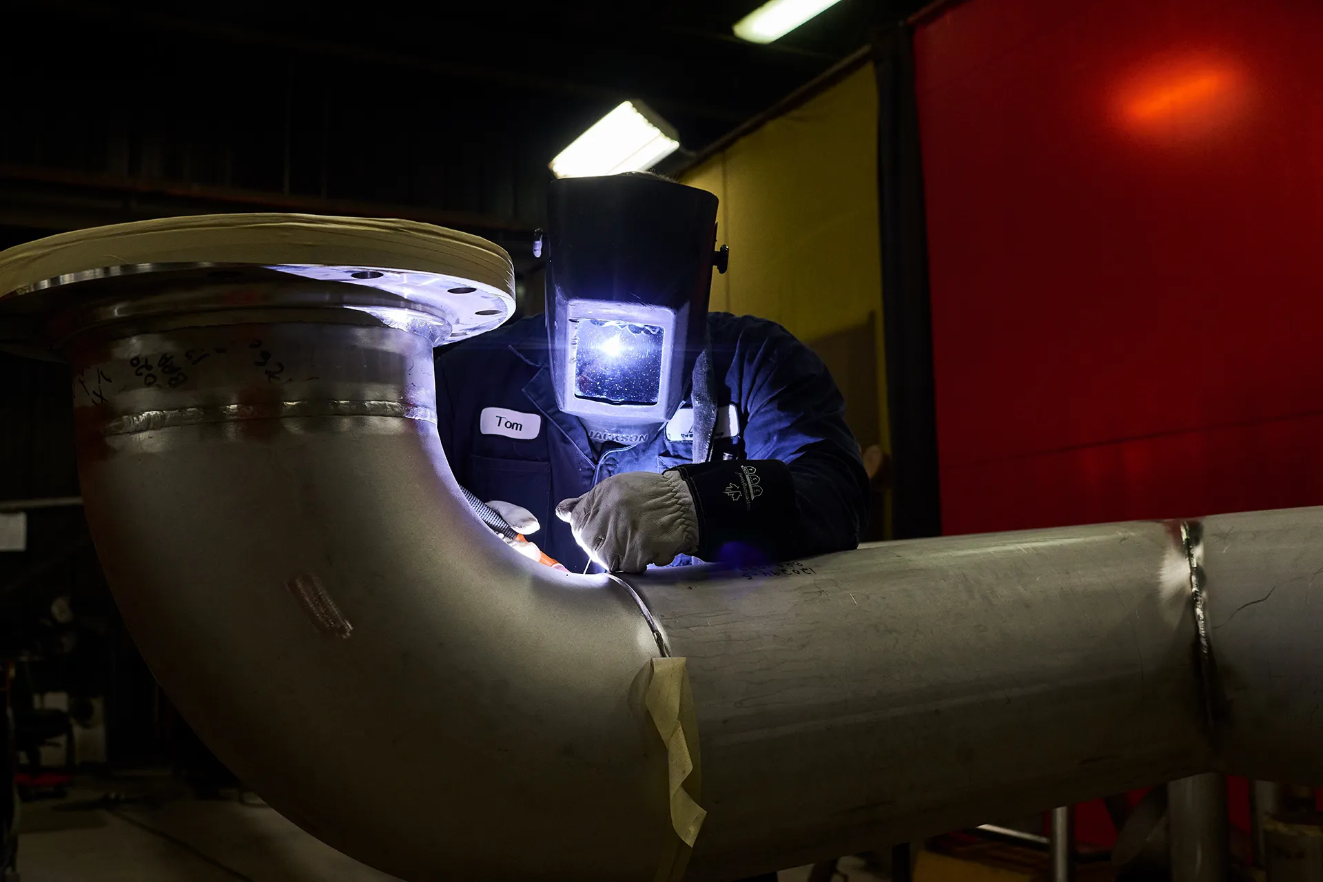 Worker welding pipe