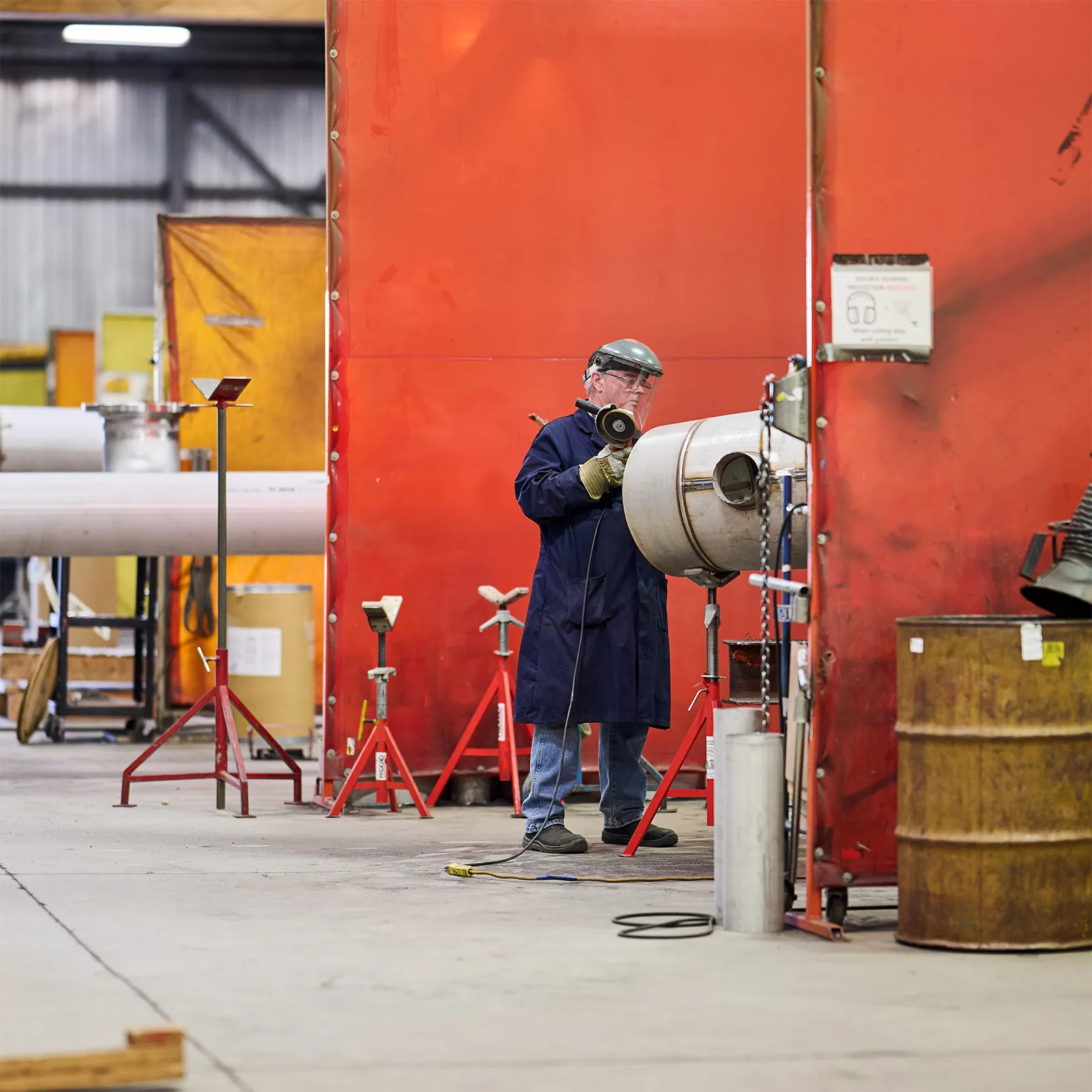 worker grinding pipe